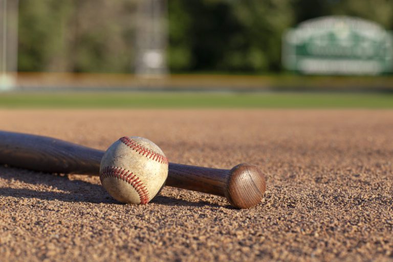 Baseball and bat low angle selective focus view on a baseball field